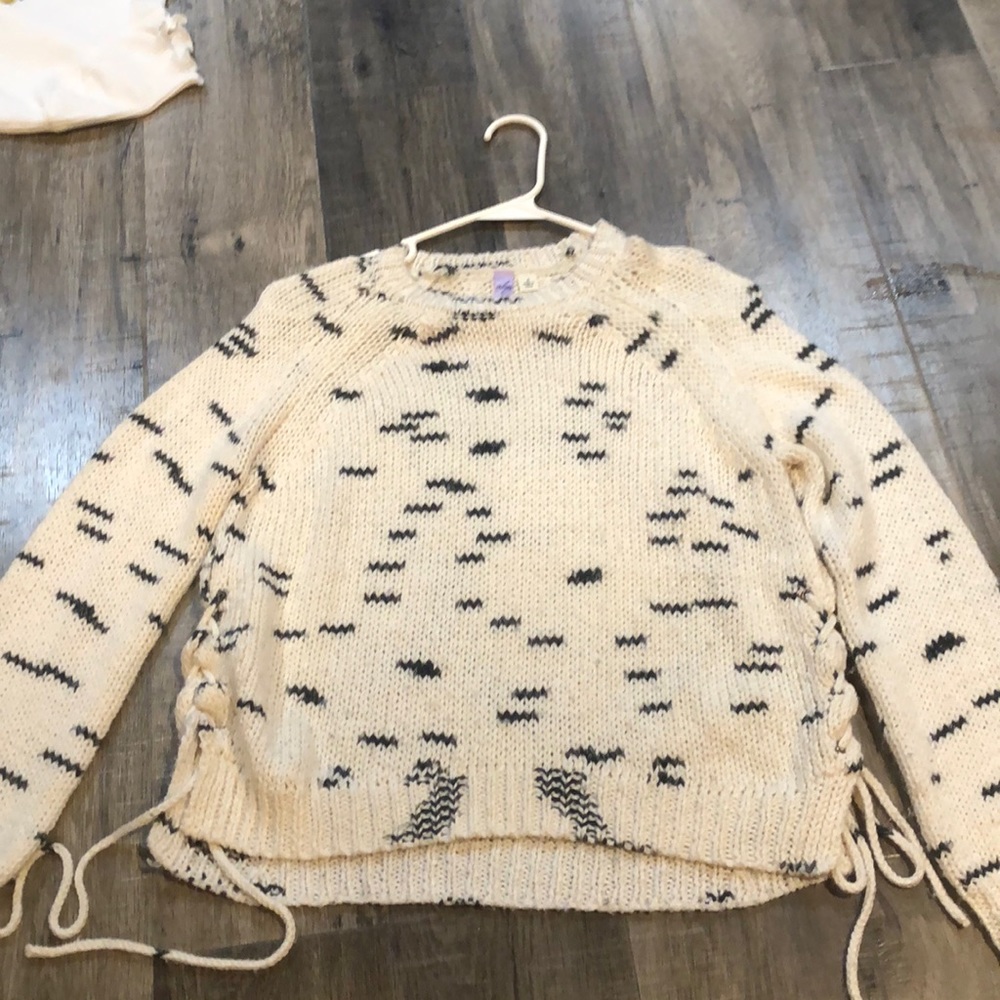 This is a Cream/ White coloured Sweater it is a small